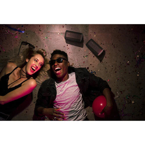 Klipsch Nashville 18W Portable Bluetooth Speaker Waterproof 360 Audio
Two people lying on a floor with confetti, one holding a red balloon.