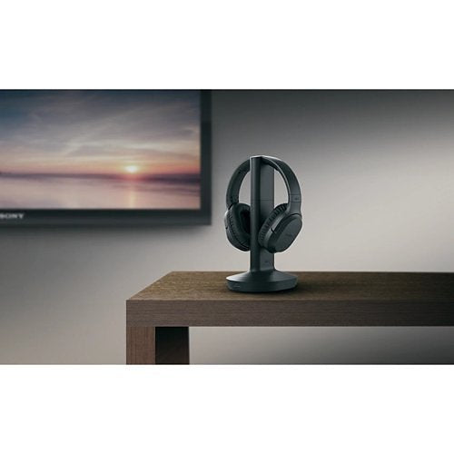 Sony Headphones WH-RF400 Wireless Mounted on a stand in a room on a table next to a TV Screen in the evening light