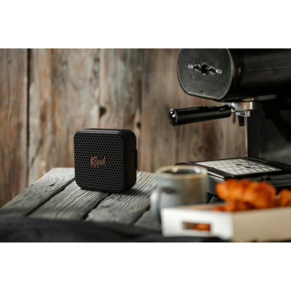 Klipsch Austin 18W Portable Bluetooth Speaker Waterproof Microphone
Kreol Bluetooth speaker on a wooden surface with an espresso machine in the background