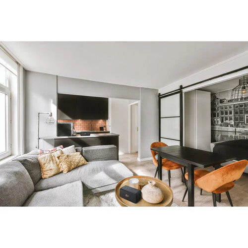 Klipsch Nashville 18W Portable Bluetooth Speaker Waterproof 360 Audio
Modern living room with gray sectional sofa, dining table, and orange chairs.